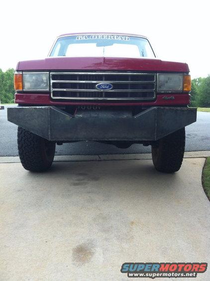 Red Ford truck front view with custom bumper and 'GA OFFROAD' banner