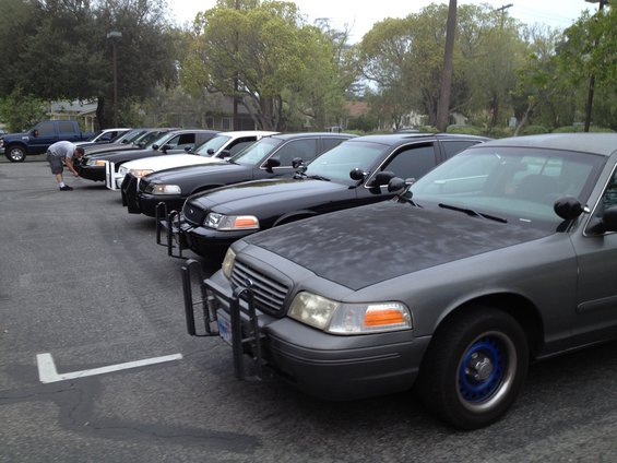 Gray 2004 Ford Crown Victoria police car with blue wheel rims and push bumper