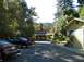 2002 Ford Taurus - A black sedan is parked in a driveway with a yellow house in the background. The license plate reads LZY097.