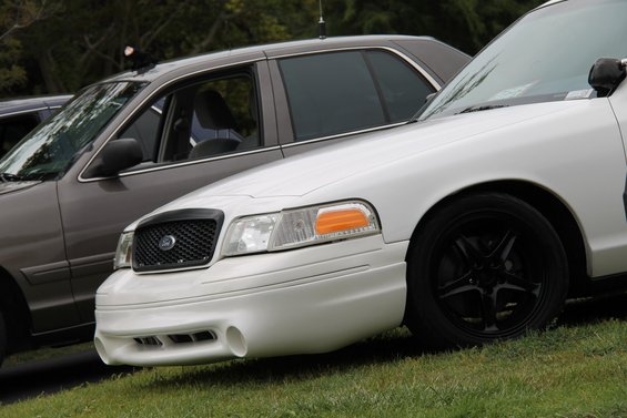White 2004 Ford Crown Victoria front quarter view with black grille and wheels