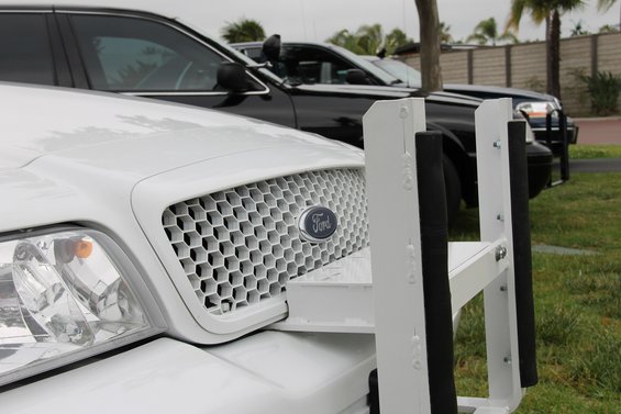 White 2004 Ford Crown Victoria with push bumper and honeycomb grille