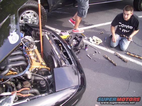 1993 Ford Probe engine bay with parts on the ground