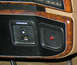 1990 Ford Bronco - The dashboard features wood grain trim around the overdrive switch and a lit red indicator light.