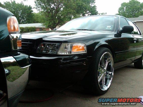 Black 2003 Ford Crown Victoria parked next to another dark vehicle