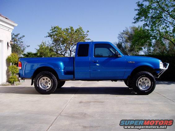 Blue 1998 Ford Ranger extended cab pickup truck parked on concrete driveway