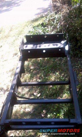 Version 1.5 of the cooler rack.  A water jug sits on that plate, which is high enough to clear the hitch and trailer tongue when closed.  Still looks ugly as hell, though.