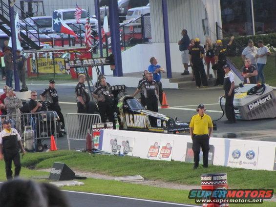 U.S. Army dragster on track with crew and DieHard refueling station