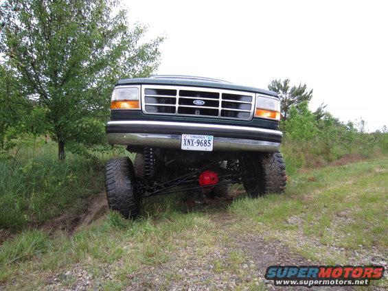 Green 1992 Ford Bronco front view with lifted suspension and large tires