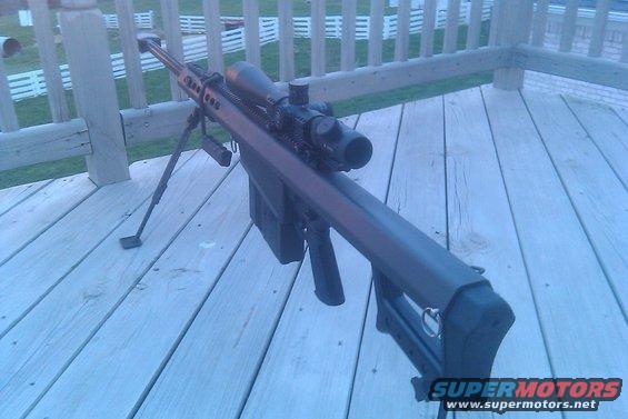Sniper rifle with scope and bipod on a wooden deck