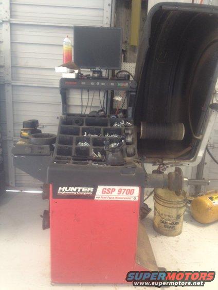 Hunter GSP 9700 wheel balancer with computer monitor and parts organizer