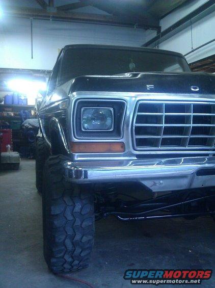 Front view of a lifted 1978 Ford Bronco with large tires and chrome grille
