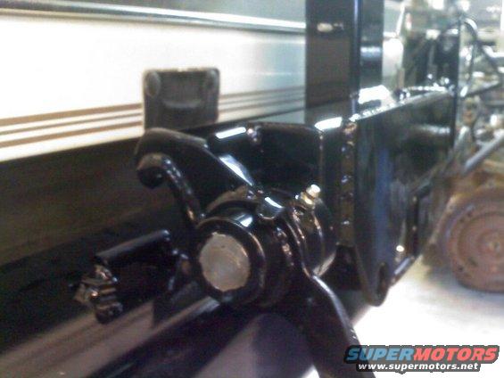 Black suspension part with silver bolt head, close-up angle
