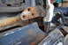 1986 Ford Bronco - The extensive rust on this door hinge and surrounding body panel indicates significant wear and tear on the 1986 Ford Bronco.