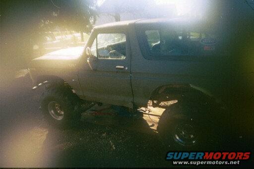 Gray 1978 Ford Bronco with lifted suspension and large tires, viewed from the side