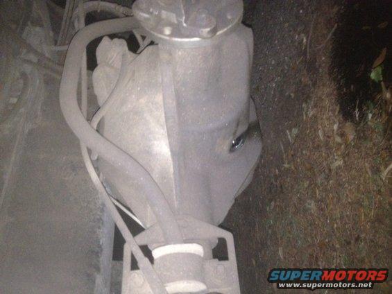 Close-up of a dusty rear differential housing with hoses attached
