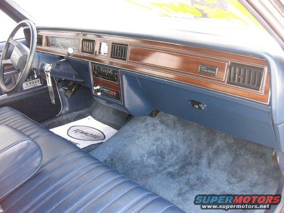 Interior of a 1985 Ford Crown Victoria LTD showing the dashboard and blue seats
