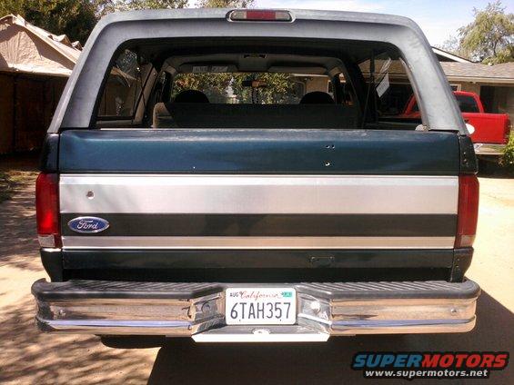 1994 Ford Bronco rear view with California license plate 6TAH357. Red truck visible in background