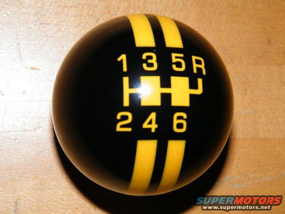 Black shift knob with yellow stripes and 6-speed gear pattern including reverse