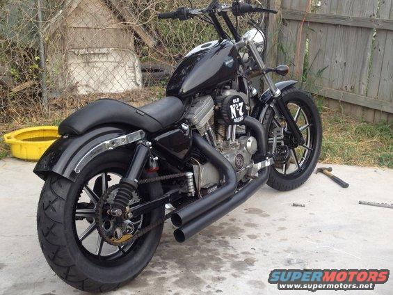 Black Harley-Davidson Sportster with custom pipes and handlebars. Has an 'Old No. 7 Brand' air cleaner cover