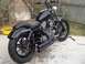 1995 Ford Bronco - A custom Harley-Davidson Sportster sits outside with a yellow oil drain pan nearby.