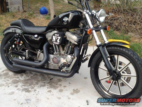 Black motorcycle with a yellow front fender and a Jack Daniel's "Old No. 7" air cleaner cover