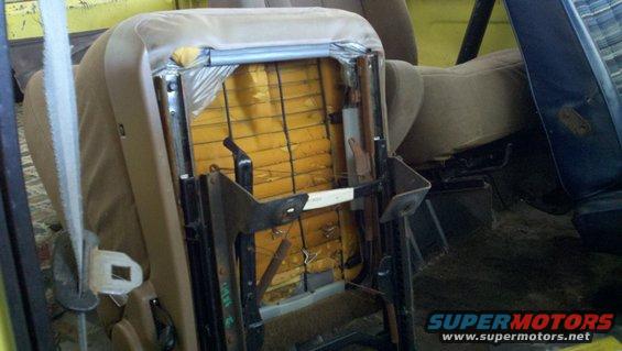 Disassembled car seat interior with exposed springs and upholstery