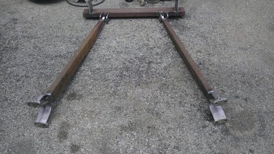 Custom A-arm suspension part made of welded steel bars on concrete