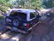 1992 Ford Bronco - This 1992 Ford Bronco is navigating a muddy trail, with its rear end partially submerged in the mire.