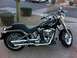 1978 Ford Bronco - A black Harley-Davidson motorcycle is parked on a paved surface, its chrome details and windshield.