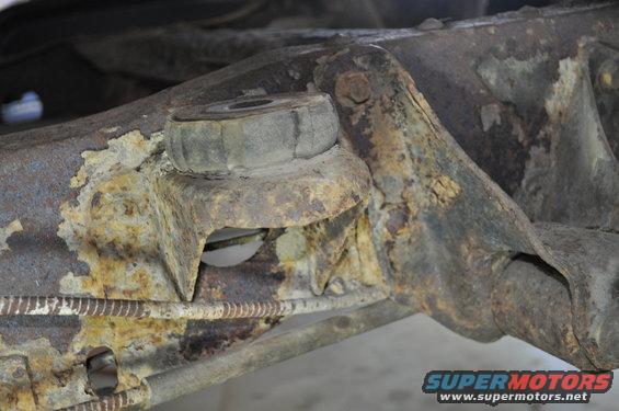 Rusted suspension part with rubber bushing