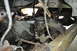 1986 Ford Bronco - Close-up of vehicle undercarriage components, including transmission and suspension parts.