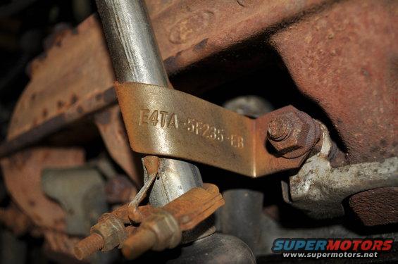 Close-up of a metal tag on an engine part with text E4TA-5F235-EB