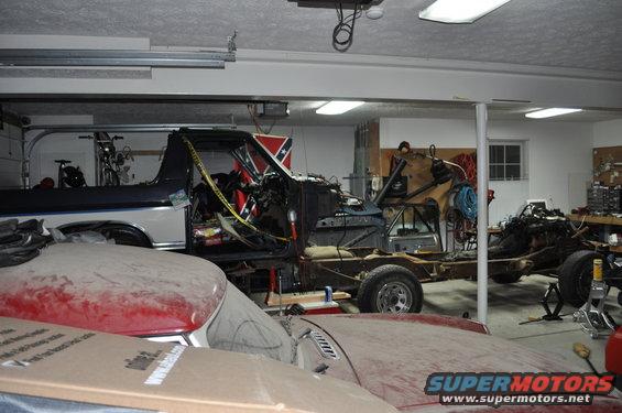 Disassembled truck in garage with Confederate flag visible