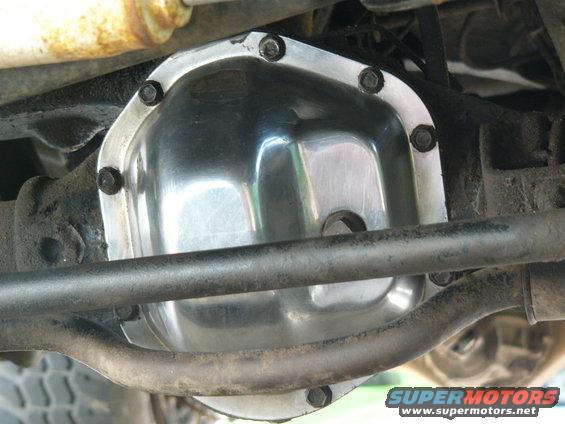 Shiny aftermarket differential cover bolted onto a vehicle's rear axle