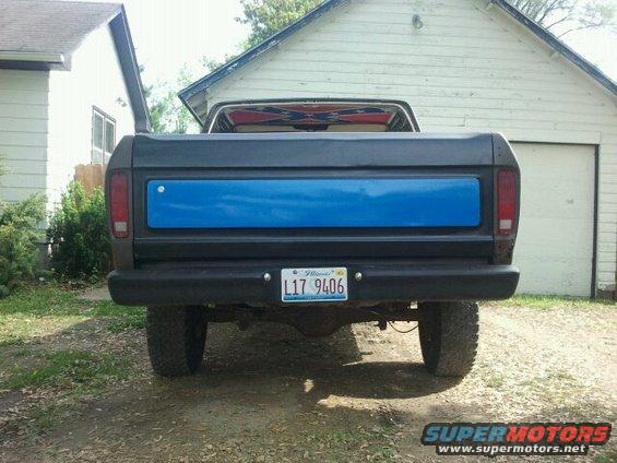Dark gray 1978 Ford Bronco rear view with a blue tailgate panel and Illinois license plate L17 9406