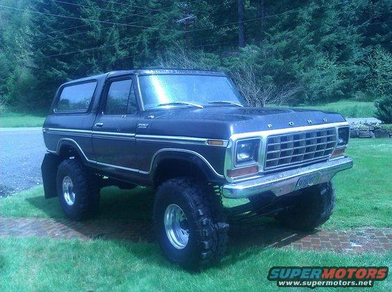 Dark blue lifted 1979 Ford Bronco with chrome grille and large tires