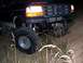 1992 Ford Bronco - This lifted Ford Bronco is navigating rough terrain at night.