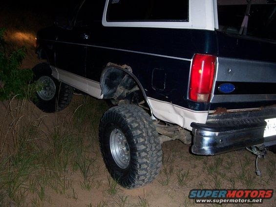 1992 Ford Bronco rear view, dark blue and white, off-roading