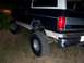 1992 Ford Bronco - This 1992 Ford Bronco is seen off-roading, with its rear end visible on uneven terrain.