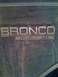 1992 Ford Bronco - The 'Bronco' and 'Eddie Bauer' emblems are visible on the dirty exterior of the vehicle.