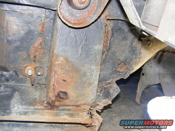rusted vehicle frame with holes and corroded metal