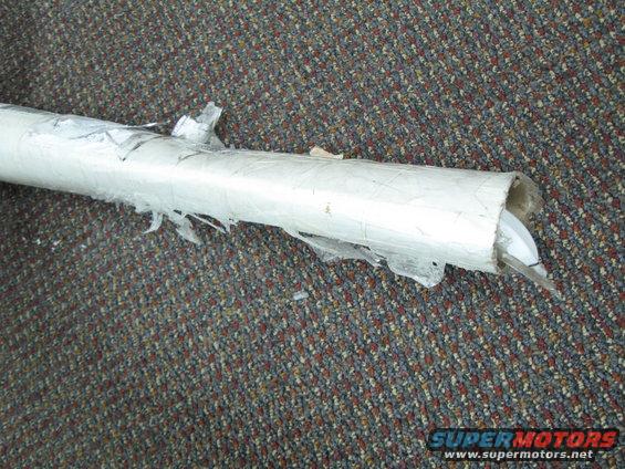 exhaust pipe wrapped in white plastic, on carpet