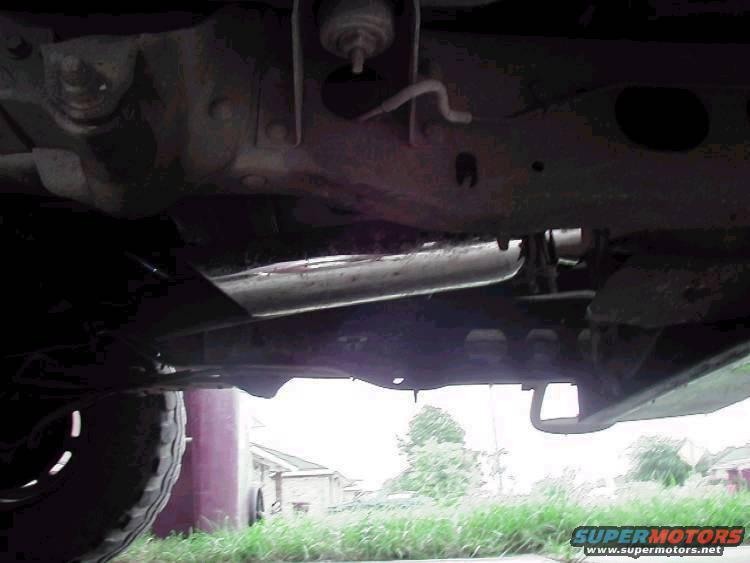 Here's my exhaust, the muffler was shot so I just hacked it off and put this tip right behind the converter, about to take off the converter and put on a free flow muffler and a tip coming out at a 45 degree angle in front the tire.