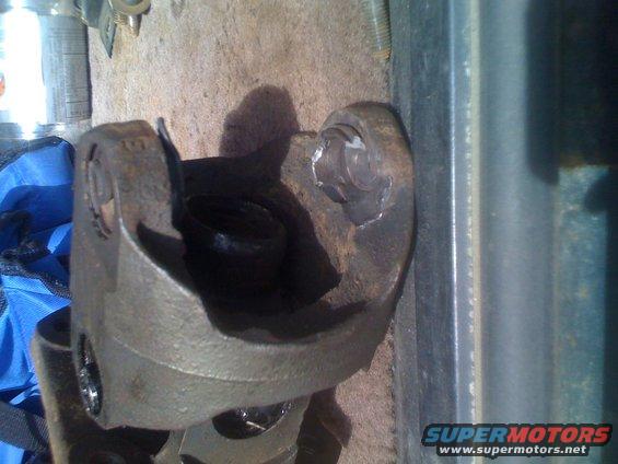 Close-up of a rusty driveshaft U-joint with bolts