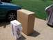 1992 Ford Bronco - A green Volvo is parked next to two large cardboard boxes on a concrete driveway.