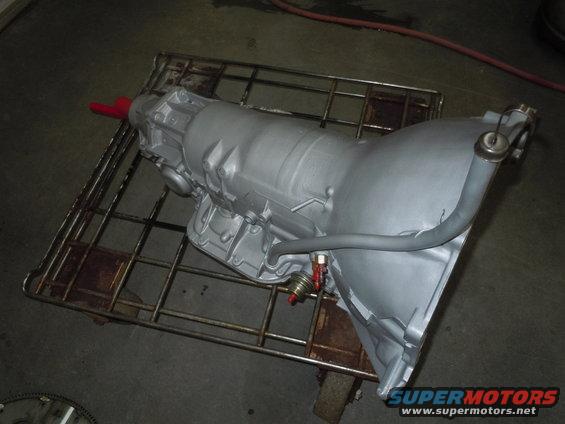 Silver automatic transmission on a metal rack