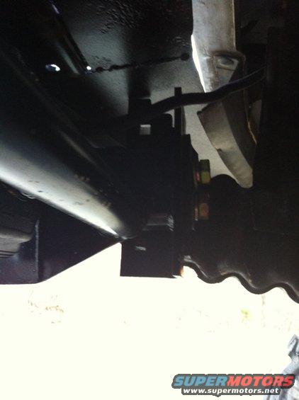Underbody suspension part with bolts and metal bracket