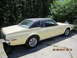1968 Mercury Cougar - This 1968 Mercury Cougar coupe is seen from the rear quarter angle, a yellow body and a black vinyl roof.