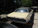 1968 Mercury Cougar - Rear view of a 1968 Mercury Cougar with a black vinyl top and light yellow paint.