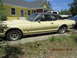 1968 Mercury Cougar - A side view of a vintage Mercury Cougar with a black vinyl roof sits parked in front of a house.
